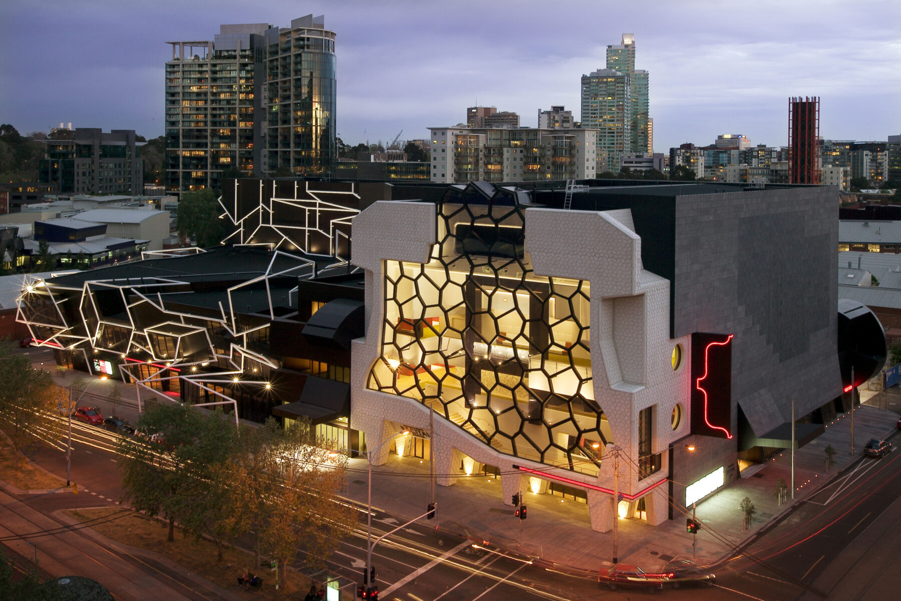 Melbourne Recital Centre's iconic honeycomb glass frontage lit up in the early evening